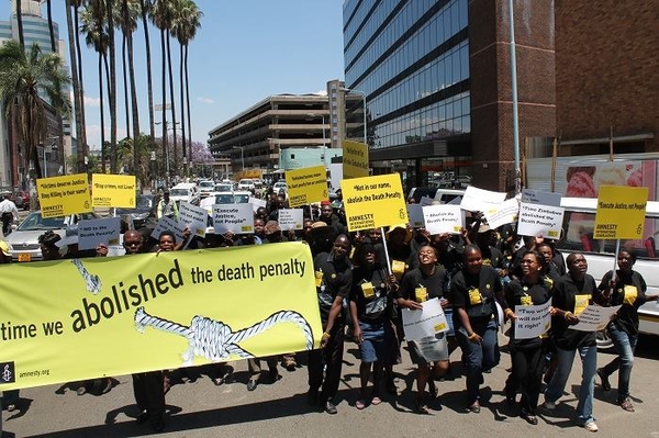 Amnesty activists march through the streets in Harare in Zimbabwe in a peaceful protest on the World Day against the Death Penalty. Photo: Al